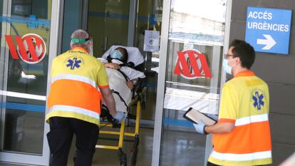 A woman is carried on a stretcher at Arnau de Vilanova hospital in Lleida.