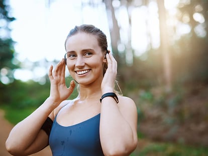Una chica colocándose los auriculares de conducción ósea.