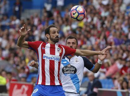 El centrocampista turco del Deportivo Emre Colak (d) y el defensa del Atlético de Madrid Juanfran (i) disputan el balón.