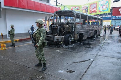 Soldiers on patrol in Acapulco, where armed groups set fire to vehicles including municipal buses during a wave of violence in the city.  