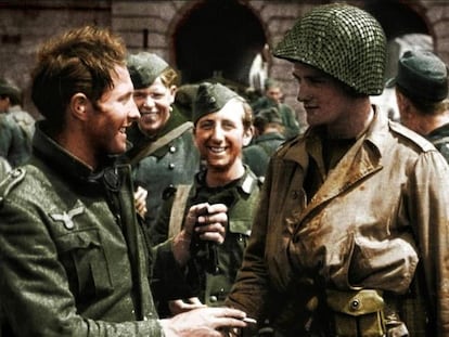 A German soldier and a US GI greet each other after the end of the Second World War.