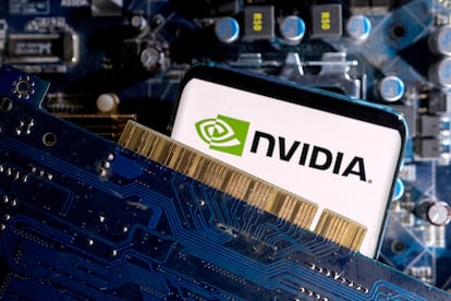 A smartphone with a displayed NVIDIA logo is placed on a computer motherboard in this illustration taken March 6, 2023