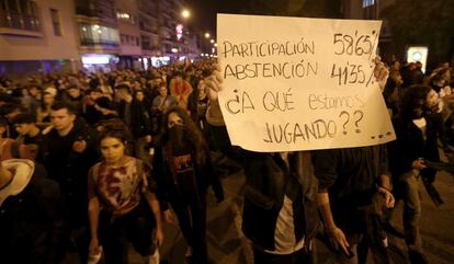 Un manifestante muestra una pancarta en relación con la participación en las elecciones andaluces durante las protestas en Sevilla.