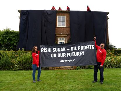 Activistas de Greenpeace, tras cubrir con una tela negra la mansión de Rishi Sunak en Richmond (Yorkshire, Inglaterra), el pasado 3 de agosto.