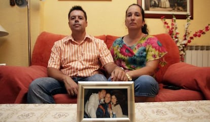 Rafael y Tatiana, junto a una foto de ellos con Harold, en su domicilio de Madrid.