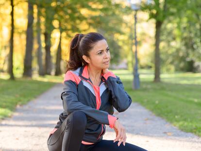 A woman takes a break during a workout.