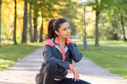 A woman takes a break during a workout.