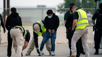 Agents frisk Guatemalan migrants before deportation on May 5, 2023 in Harlingen, Texas.