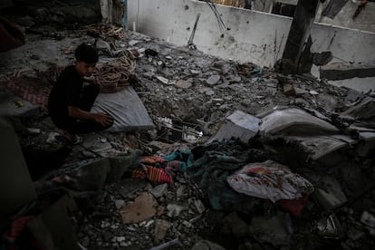 A Palestinian boy stands in the rubble after the Israeli army attacked the school of the United Nations agency for Palestinian refugees 