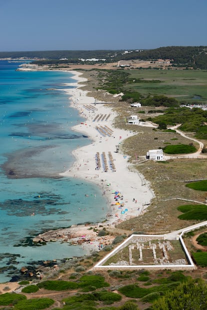 Son Bou, Alaior (Menorca). Una de las gracias indiscutibles de esta basílica paleocristiana (siglos V-VI) es el lugar en que se halla situada, con el Mediterráneo a unos pasos y el estupendo perfil de la playa de mayor largura de la isla de Menorca. De planta rectangular 
dividida en tres naves, su rasgo significativo es la pila bautismal tetralobulada. En la zona arqueológica veremos tumbas antropomorfas excavadas en la roca. La mejor idea es dejar el coche en el aparcamiento principal, para al regreso disfrutar del arenal y sus chiringuitos. 