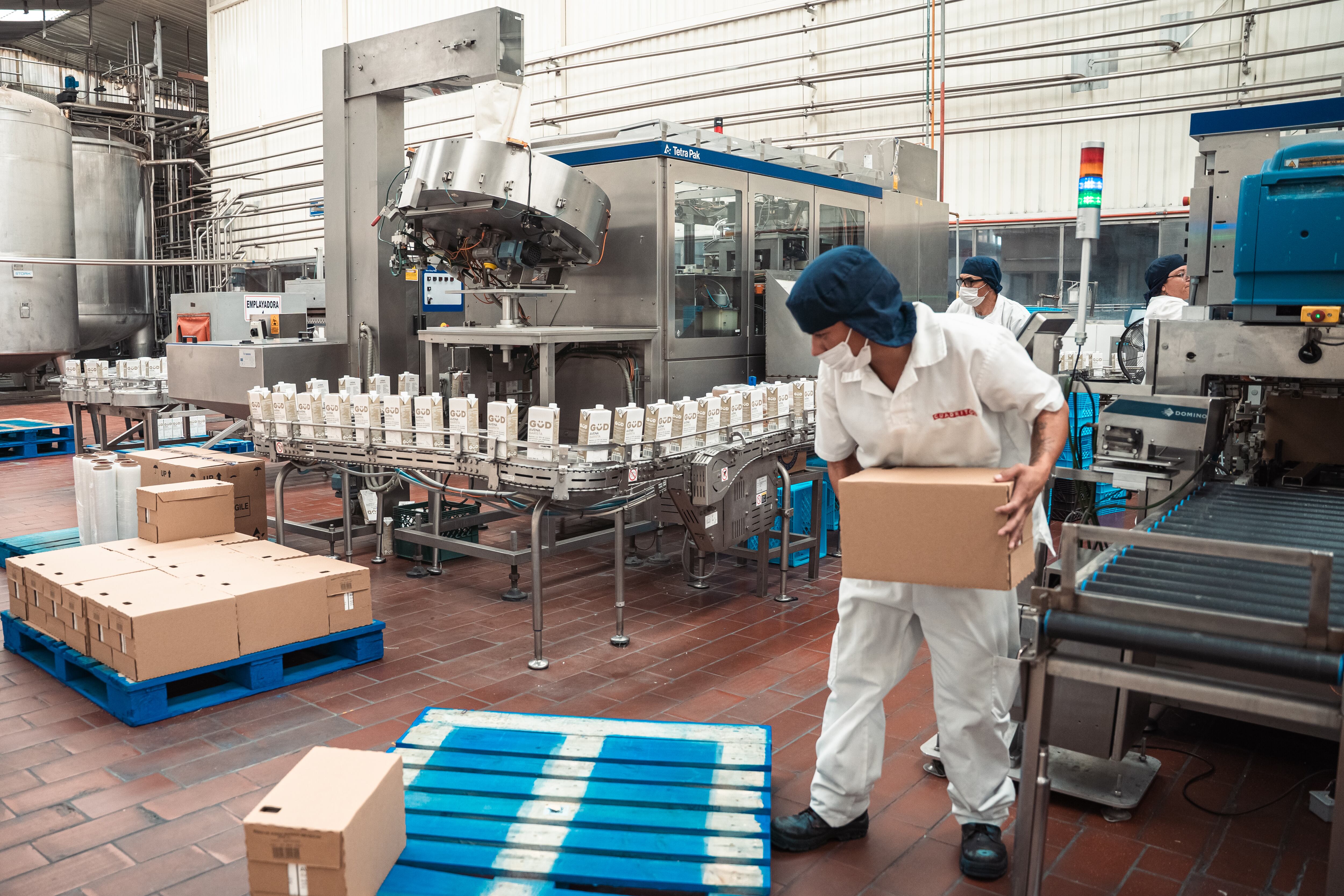 Trabajadores se encargan de los empaques de bebida de avena de la marca GÜD, el 3 de septiembre.