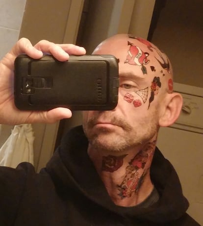 Chuck Palahniuk in a selfie he shares with ICON from his book cover shoot, in which he got several fake tattoos on his face.