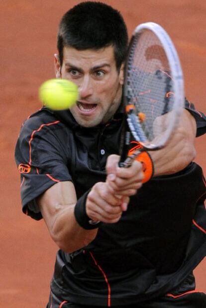 Djokovic returns the ball against Nadal in Madrid.