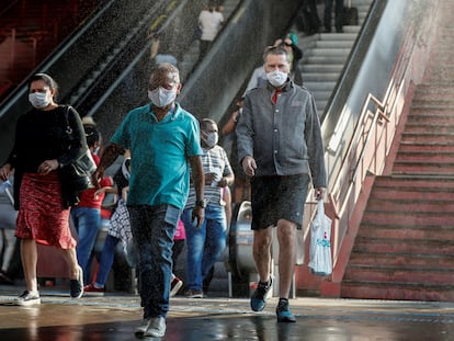 Usuário passam por cabine de desinfecção em estação de metrô de Osasco (SP).