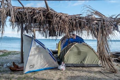 A migrant rests in a tent on a beach in Necoclí. 