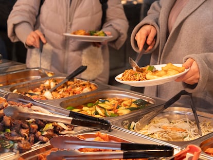 Dos personas se sirven comida en un restaurante chino de Londres.