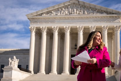 Lorie Smith, a Christian graphic artist and website designer in Colorado, prepares to speak to supporters outside the Supreme Court in Washington