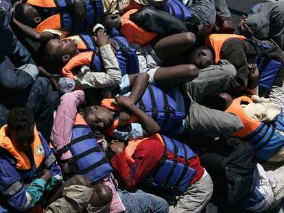 Inmigrantes rescatados hace dos días por un barco siciliano descansan en un buque de la Armada de Malta.