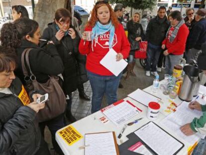 Varios miembros de la PAH, en el puesto de información instalado en el centro de Valencia.