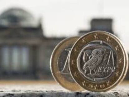Dos monedas de euro, una de ellas acuñada en Grecia, fotografiadas delante del Bundestag en Berlín (Alemania). EFE/Archivo