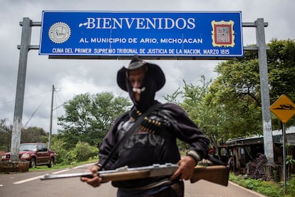 A member of the Pueblos Unidos citizen’s militia stands guard to prevent cartels from entering a town in Michoacan.