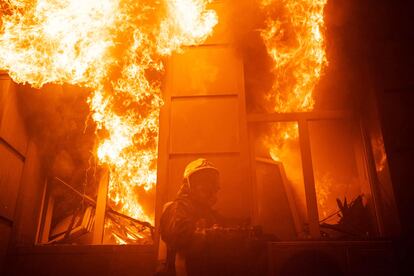 This handout photograph taken and released by the Ukrainian Emergency Services on July 20, 2023, shows rescuers extinguishing a fire in an administrative building in Odesa. 