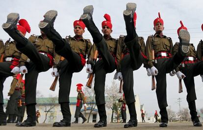 Indian army recruits wearing their ceremonial uniform perform a salute as they pose before their passing out parade at a garrison in Rangreth on the outskirts of Srinagar, March 5, 2016.