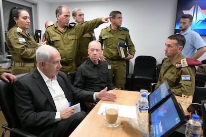 A photo distributed by the Israeli Government Press Office shows Israeli Prime Minister Benjamin Netanyahu (left) during a situation assessment meeting in Tel Aviv on October 8, 2023.