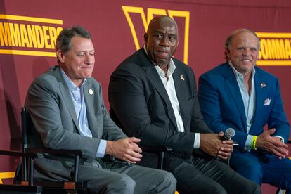 Owner of the Washington Commanders NFL team Earvin 'Magic' Johnson (C) looks on during a press conference at FedEx Field in Landover, Maryland, USA, 21 July 2023.