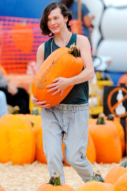 Estos días el mercado de calabaza de Los Ángeles se ha convertido en un punto de reunión de celebrities de Hollywood. En la imagen Milla Jovovich carga con una de estas piezas que dentro de unos días formará parte de la decoración de su casa.