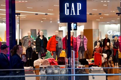 A woman shops at a Gap store as holiday shopping accelerates at the King of Prussia Mall. 