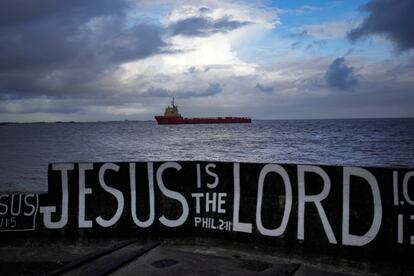 A ship carries materials to an ExxonMobil oil platform in April 2023.