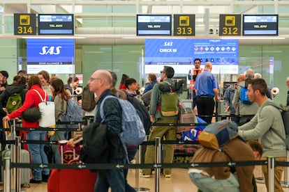 Cola de pasajeros en los puestos de facturación de la aerolínea escandinava SAS en el Aeropuerto Josep Tarradellas Barcelona-El Prat para facturar su equipaje para un vuelo a Tel Aviv (Israel).