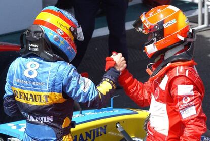 epa000226303 Formula One World champion Michael Schumacher shakes hands with second place Spanish Renault driver Fernando Alonso (L) after winning the French Formula One Grand Prix held at Mangy-Cours, Sunday 04 July 2004. Schumacher never looked back en route to his ninth victory in 10season races and his 79th overall in 1 hour 30 minutes 18.133 secondsfor the 70-lap race over 305.586 kilometres. Alonso had to settle for second and Renaultës agony was complete when Rubens Barrichello stole third. EPA/Oliver Multhaup EFE/epa/Oliver Multhaup