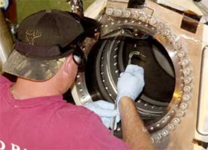 Un trabajador de la NASA instala una cámara de fibra óptica en la nave Endeavour.