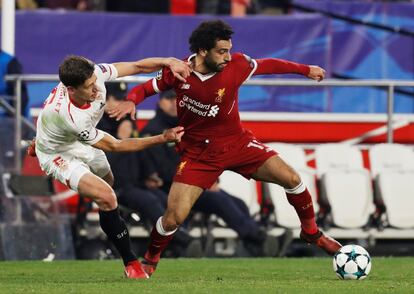 El jugador del Liverpool, Mohamed Salah, lucha el esferico con el sevillista Clement Lenglet.