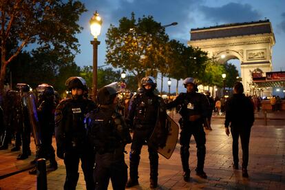Police officers patrol in front of the Arc de Triomphe on the Champs Elysees in Paris, Saturday, July 1, 2023.