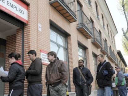 People standing in line outside an unemployment office in Alcalá de Henares (Madrid).