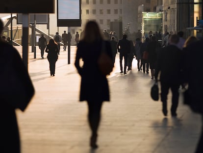 Silhouette of businesswoman among other commuters at modern business district