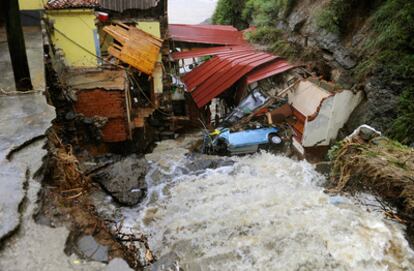 Puerto Lampero, Asturias, con varias casas y vehículos afectados por la crecida del nivel de la agua.