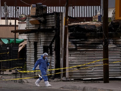 A forensic technician works at a scene where a man threw a Molotov cocktail bomb after being kicked out of a bar for bad behavior, leaving several victims, according to Sonora state authorities, in San Luis Rio Colorado, Mexico July 22, 2023. REUTERS/Victor Medina