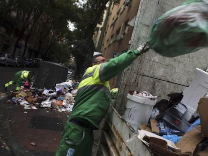 Un trabajador del servicio de limpieza viaria de Madrid limpia los restos de la huelga.