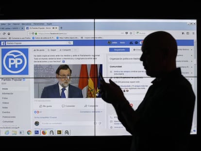Un hombre frente a una pantalla con la p&aacute;gina de Facebook del Partido Popular.