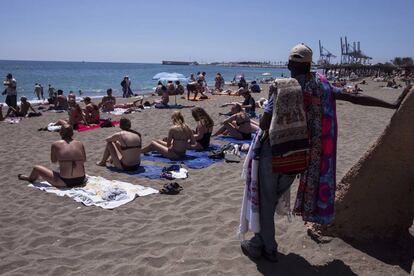 Sunbathers on Malagueta beach in Málaga.