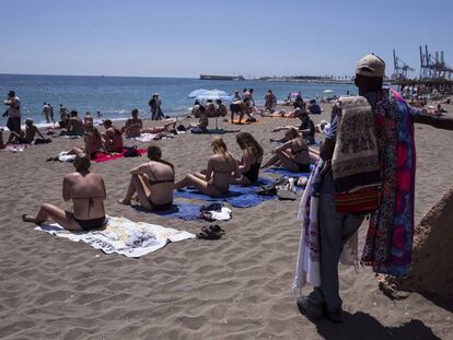 Sunbathers on Malagueta beach in Málaga.