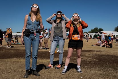 Chloe Haynes, Jatzin Alvarado and Emma Gorski watch the eclipse through their eclipse glasses on the second day of the second weekend of Austin City Limits Music Festival, Saturday, Oct. 14, 2023. 