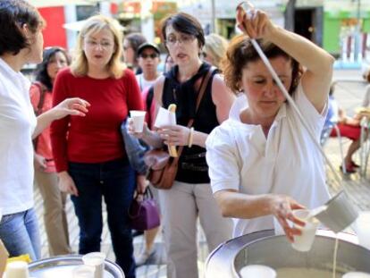 Un grupo de viandantes prueba la horchata de la calle Alcalá.