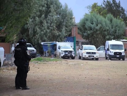 Security personnel guard the site where a clandestine grave was found in the municipality of Irapuato, Guanajuato, on May 24.