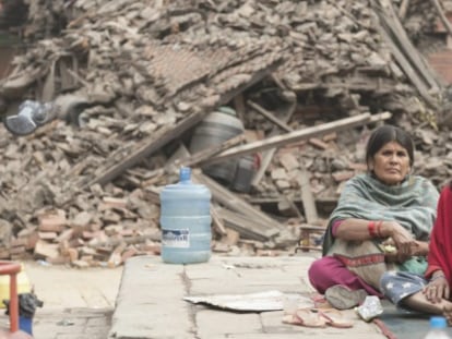Dues dones, aquest diumenge, davant un edfici destruït a la regió de Katmandú.