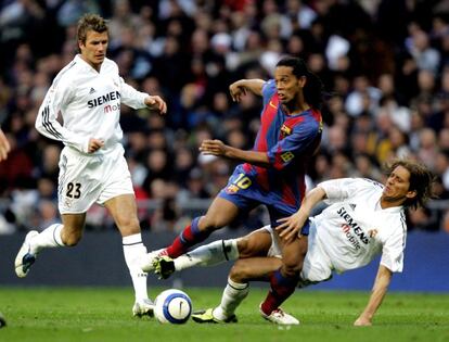 Michel Salgado (derecha) frena un avance de Ronaldinho (centro) en presencia de Beckham (08-04-2005)